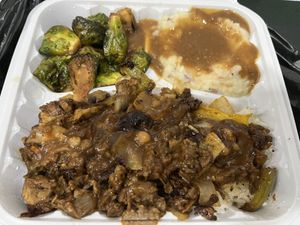Stayk tips with onions & peppers, mashed potatoes with gravy, and roasted Brussels sprouts. All vegan!!  at Taste Of Vegan Soul in Charlotte