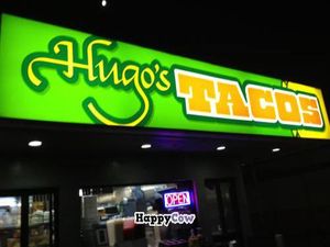 Sign is lit up at night, making it an easy find at Hugo's Tacos - Atwater Village in Los Angeles