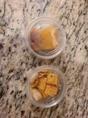 Samples she gave me to try, one is a seasoned chex mix, and the other is a lemon bar. at Farmers Market in Fayetteville