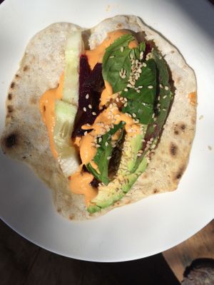Vegan tortilla with cashew red pepper sauce and veggies. Home made bread. at Between Tides in Lobitos
