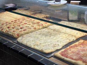 Two types of focaccia and a pizza with onions    at Panfé in Bologna