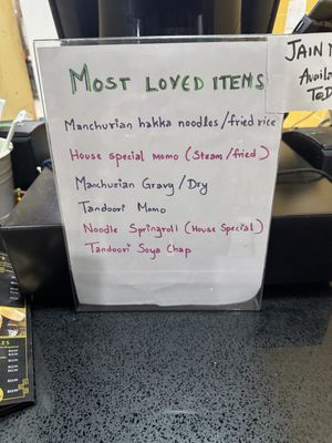 Most popular items displayed at cash  at Momo Hub in Brampton