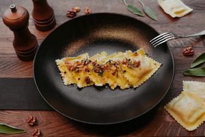 Ravioli Pasta filled with porcini mushrooms accompanied by flavours of sage and walnut. So light, healthy and comforting! at Primo Pasta Amsterdam in Amsterdam