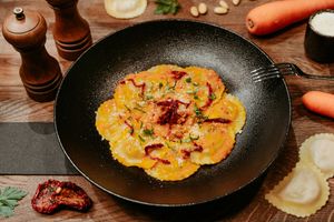 Ravioloni pasta filled with grilled vegetables and soaked in a red almond pesto. So nutty, creamy and complete! at Primo Pasta Amsterdam in Amsterdam