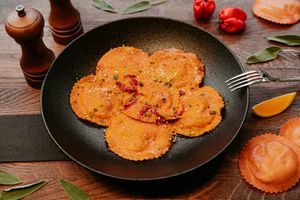 Ravioli Pasta filled with pumpkin accompanied by saffron and orange. An all around mind-blowing dish for sophisticated palates. at Primo Pasta Amsterdam in Amsterdam
