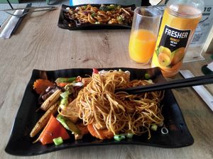 Stir fry noodles, spicy udon and mango juice at EatHappy Vegan - Rosenhoff in Oslo