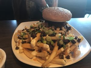 Bbq "beef" burger with crispy onion rings, mac and cheese and bacon ranch fries at The Happy Hooligans in San Jose