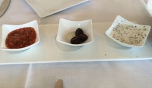 dipping sauces and olives with home made bread. Red sauce is vegan and spicy, white sauce vegetarian not vegan. at Istanbul Restaurant in Williamsburg