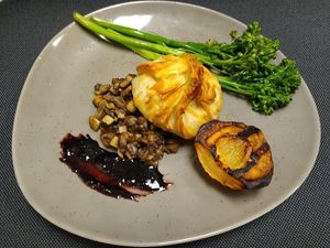 White Bean and Fennel Phyllo Purse  with grilled pear and broccolini, and a Port Wine Sauce (v)
 at American Harvest Restaurant in Livonia