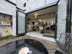 Outdoor seating looking indoors  at Mandala Café in East London
