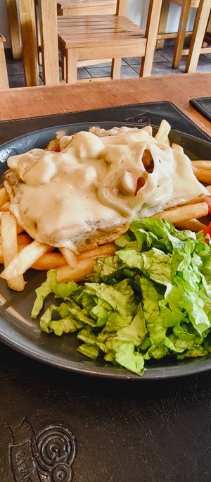 Chivito on plate at Comida Naturista Irene's in Colonia Del Sacramento