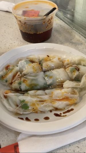 Vegan steamed rice roll filled with veggies and topped with soy sauce, chili oil, and sesame seeds.   at Joe's Steam Rice Roll in Flushing