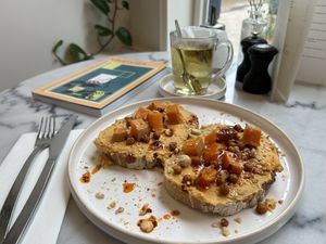 Smashed pumpkin on bread with chili oil and crunchy chickpeas.  at June  in Tilburg