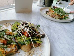 Avocado with chestnut mushrooms and carrot with tahini dressing sandwiches at June  in Tilburg