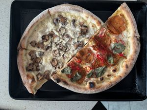 Half a fun guy and half a hottie pizza ready for reheating the next day at HOT PLANTS in Prague