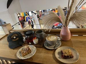 Oat milk latte, vegan bakes  at Elm Cafe in Keswick