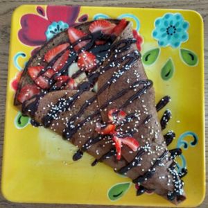 full size chocolate pancake with strawberries and bananas at La Senda Restaurante in Playa Del Carmen
