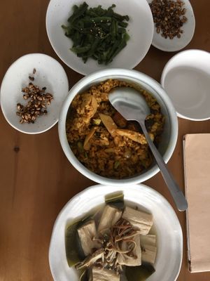 Top to bottom: seaweed salad, turmeric mushroom rice, yuba and kelp cooked in broth. Puffed oats were served as an amuse-bouche.  at Gu Li Zi Ran Feng Wei in Tainan