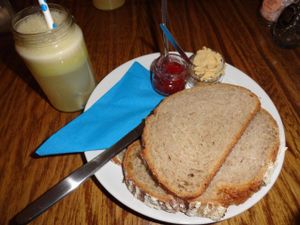 Vegan breakfast: fresh juice, bread with jam and hummus at DopHert in Amsterdam