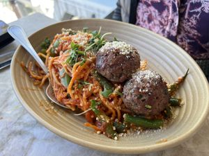 Impossible Pasta:  Palmini noodles in Pomadoro sauce with impossible meatballs, green beans, asparagus, vegan gouda cheese, vegan parmesan, micro basil.  at Malibu Farm in San Diego