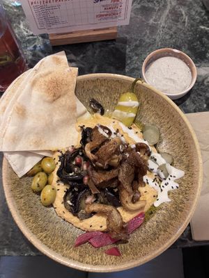 Spicy hummus with oyster mushroom shawarma, grilled aubergine and soy yogurt lime toppingg  at The Hummus Connection  in Nuremberg