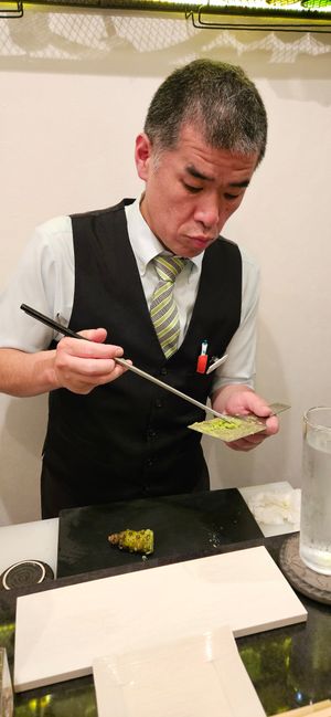 The chef preparing fresh wasabi at sushi bar fish 4 u in Tokyo