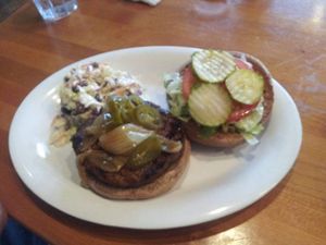 Burger with pickles and coleslaw at Veggie Grill in Laguna Niguel