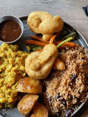 Fried dumplings, jerk sauce, veg, rice and peas, potatoes, chickpea curry  at Jamrock in Leeds