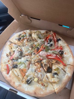 Supreme pizza with tomatoes, mushrooms, onions, peppers, feta cheese, zucchini & olives. ($15 on Slice Life)  at Bella Napoli  in Copiague