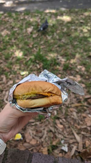 Not so happy cheeseburger uncovered. at Mr.Charlie's - Sydney in Redfern