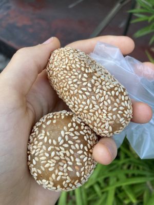Fried sesame balls. Round one is filled with peanut, long one with shredded sweet caramelized coconut  at Pan Cake and Steam Rice Cake Stall in Penang