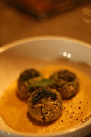 Veggie balls in a carrot cream with pesto and pumpkin seed parmasan at Aliado Bar & Aperitivo in San Juan