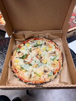 Vegan pizza with pineapple, spinach, garlic and vegan cheese    at Firenza Kitchen in Lindenhurst