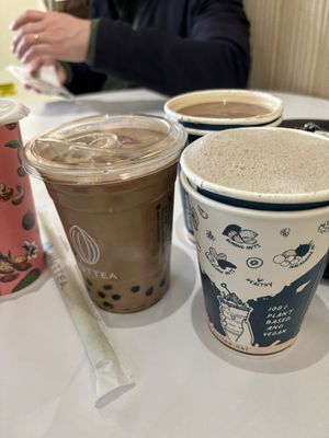 Oolong milk tea with boba, black sesame hot milk tea. Drinks in the back were a hazelnut mocha and I’m not sure what the other was.   at Nuttea in Toronto