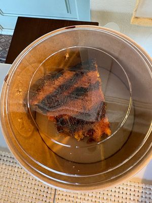 Takeaway “service”: dessert packed upside down, icing ruined, then charged extra.  at Casa Vegetariana in Porto