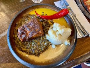 Smoke-grilled pumpkin with lentils and curry sauce at Meshek Barzilay in Tel Aviv