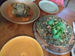 Lasagna and pizza with spinach at Meshek Barzilay in Tel Aviv