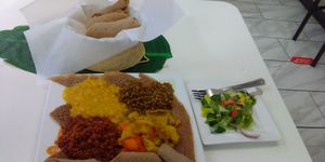 Sampler platter with injera bread and side salad. at Lulu EthioVegan in Minneapolis