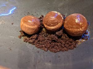Diving wasabi chocolate truffles on crunchy cookie crumbs at Rasoterra in Barcelona