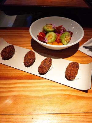 Spinach croquettes & tomato and cucumber salad at Rasoterra in Barcelona