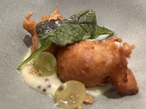 JERUSALEM ARTICHOKE fritters, potato and black mustard sauce, grapes  at Rasoterra in Barcelona