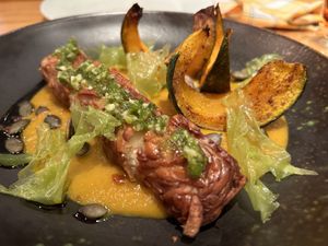 Homemade almond TEMPEH, Hokkaido pumpkin, seeds, gremolata  at Rasoterra in Barcelona