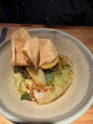 Chickpea and potato curry with a wafer thin pappadum .  at Rasoterra in Barcelona