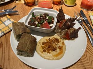 Fig, tomato and ‘feta’ tofu salad, focaccia, hummus and smoked eggplant. Amazing!   at Rasoterra in Barcelona