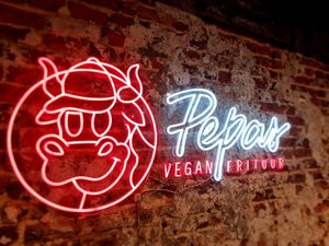 Logo on wall at Pepas Vegan Frituur in Leuven