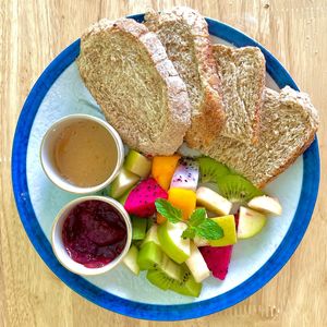 Sweet Breakfast: Mixed tropical fruit salad, peanut butter and locally produced jam with sliced whole grain bread. at Cambodhi in Kampot
