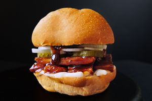 Grilled firm tofu chunks smothered in a smokey sweet BBQ sauce, topped with pickles and sliced white onions. Served with fries on the side.
 at Nabati Bistro in Dubai