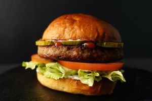 Quarter-pound Impossible patty with ketchup, mayo, tomatoes, shredded lettuce, and pickles. Served with fries on the side.
 at Nabati Bistro in Dubai
