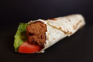 Cristpy Chick'n Wrap - Crispy Tindle Chick'n strips, tomato, lettuce and peppered mayonnaise wrapped in a toasted flour tortilla. Served with fries on the side.
 at Nabati Bistro in Dubai