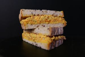 Chickpea Mayo Sandwich - Mashed chickpeas with celery, diced onions, shredded carrots, mayo and whole-grain dijon mustard in whole-grain sourdough slices.
 at Nabati Bistro in Dubai